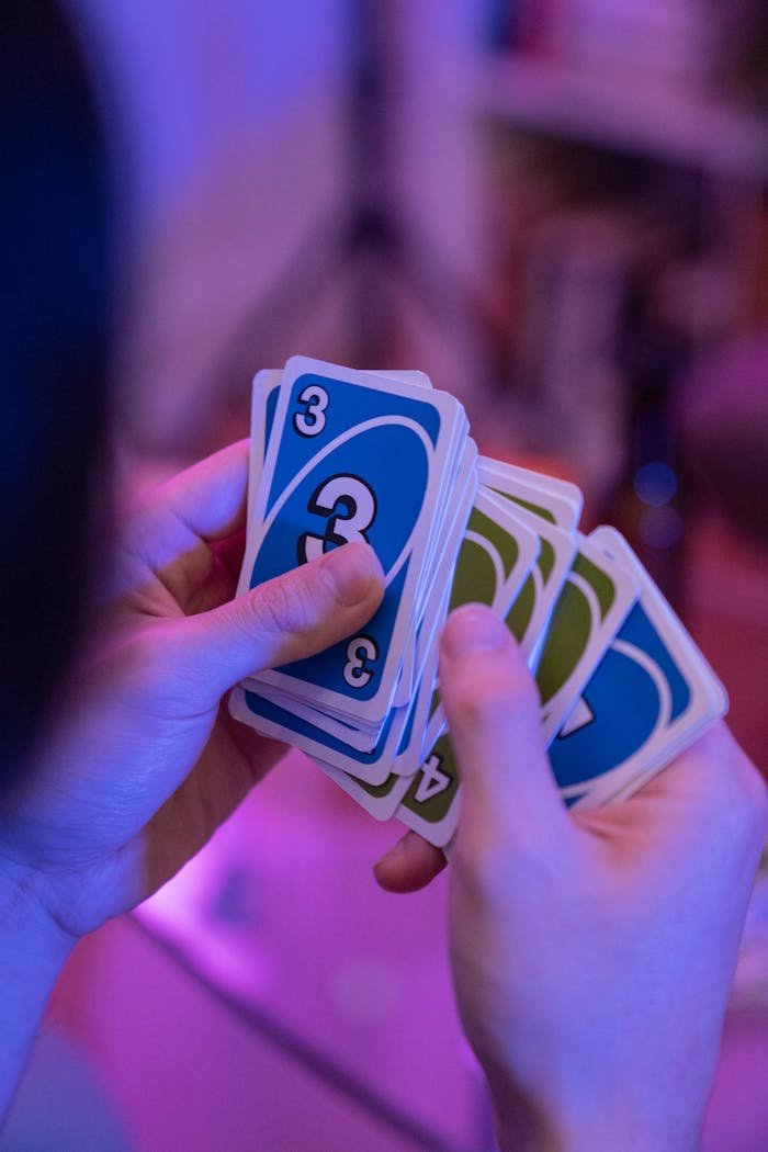 Close-Up Shot of a Person Holding Uno Cards